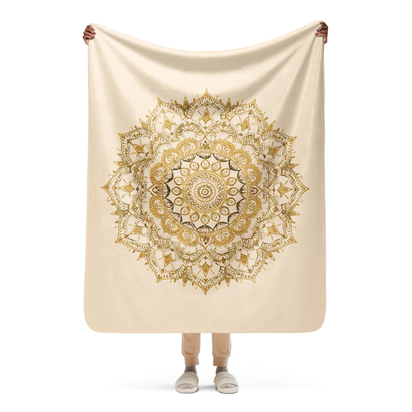 Large gold mandala on a plush sherpa blanket, soft, cozy blanket, shown in small size, held up by a woman.