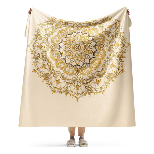 Large gold mandala on a plush sherpa blanket, soft, cozy mandala blanket, shown in XL size, held up by a woman.